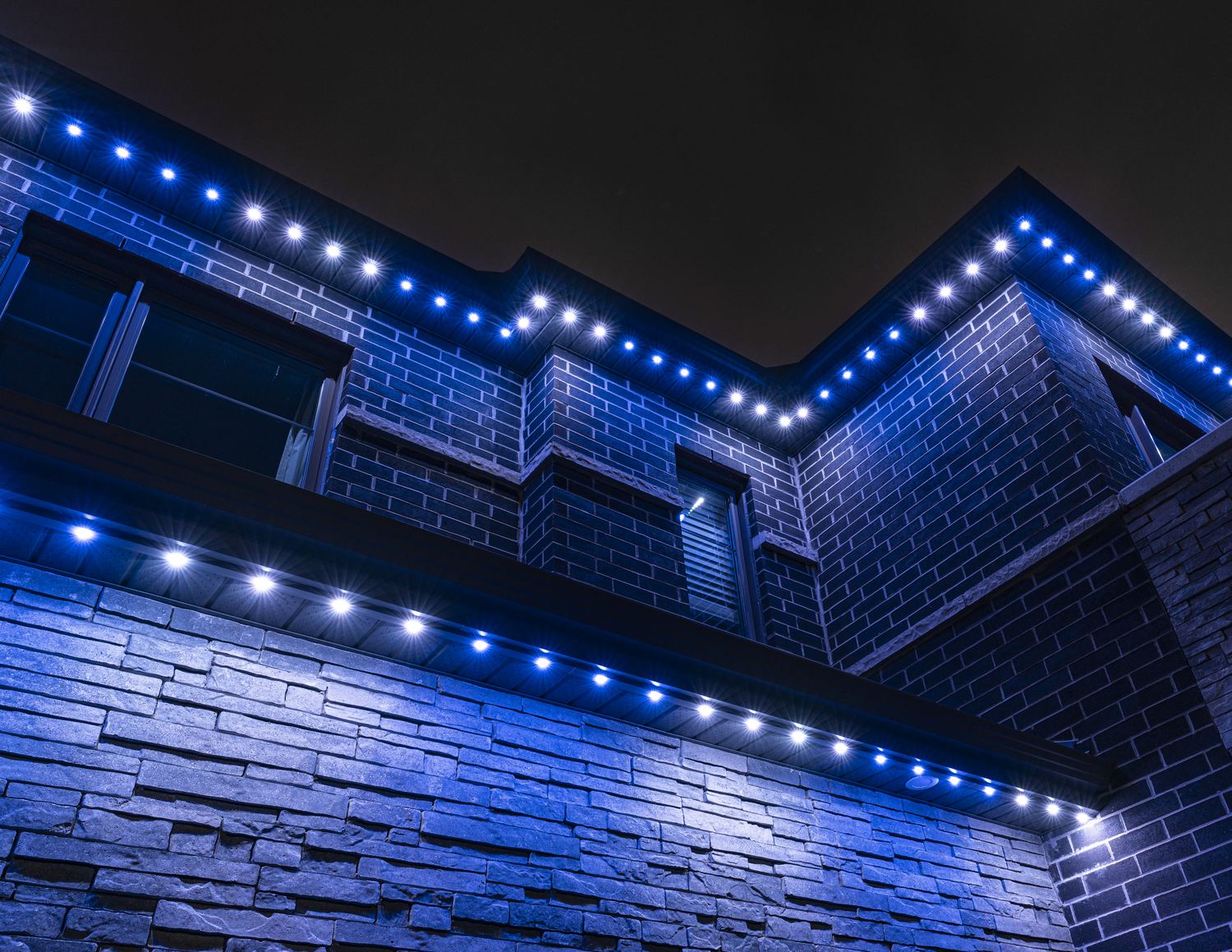 A home lit in purple permanent LED lighting for Bell Let's Talk
