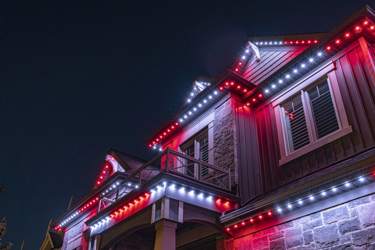 A home lit in red and white permanent LED lighting for Canada Day