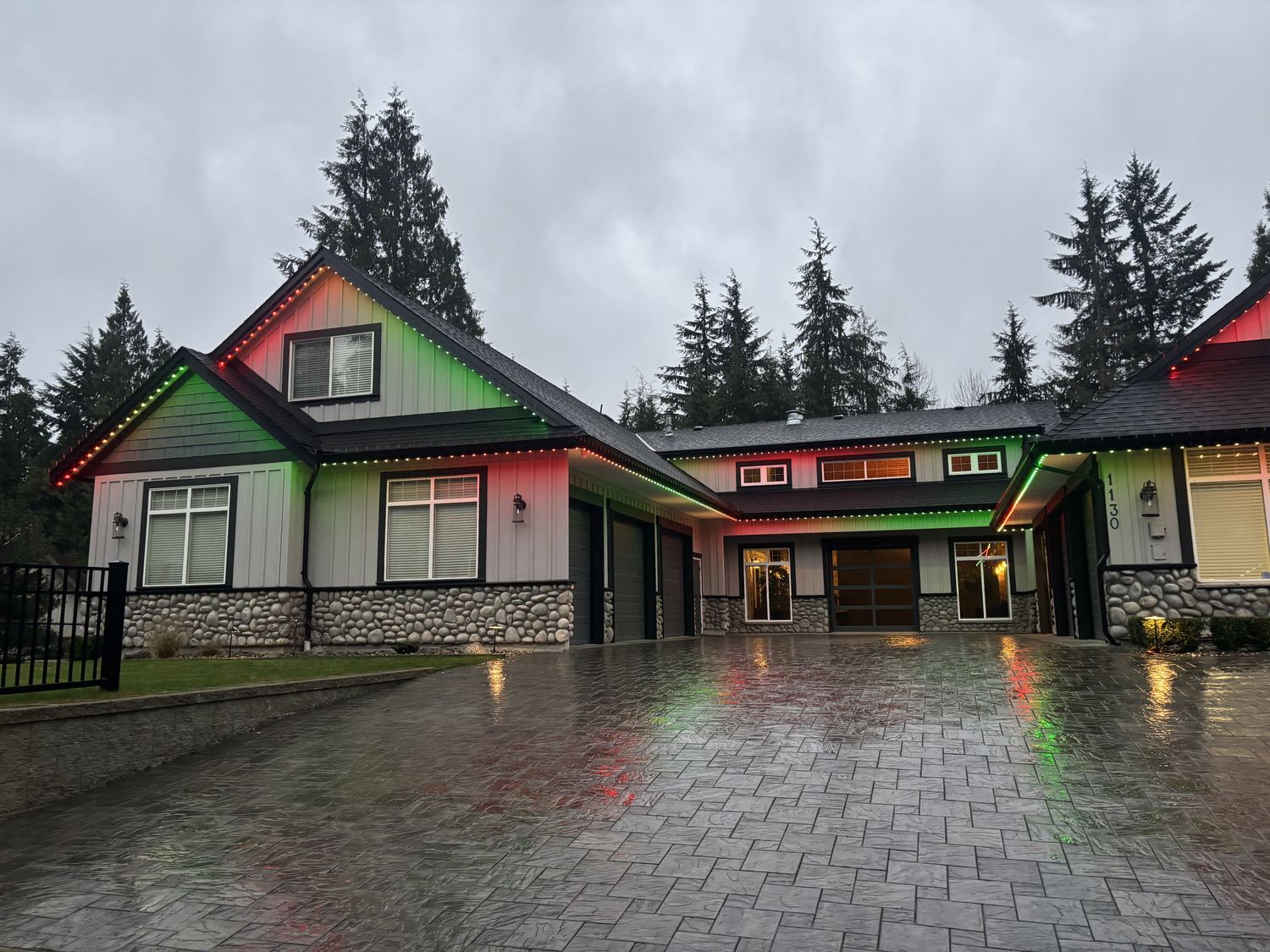 A real Delta Exterior customer home lit up in red and green permanent LED lighting
