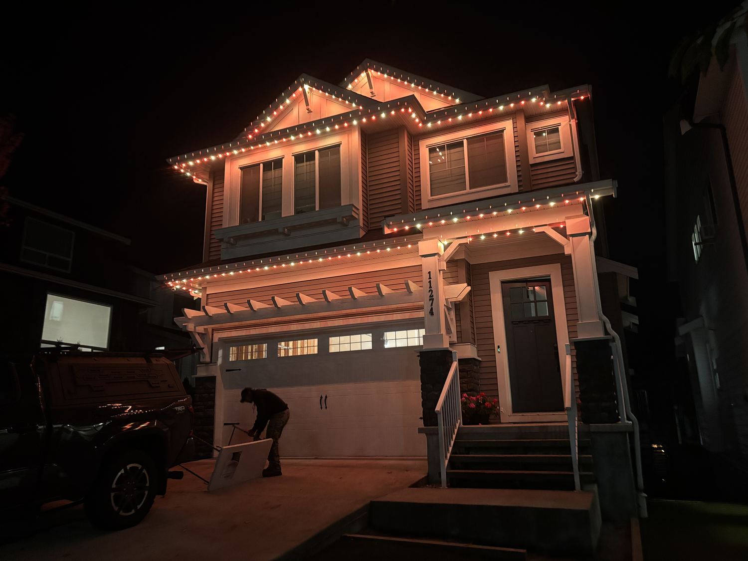 Delta Exterior technician installing permanent LED lighting on a home