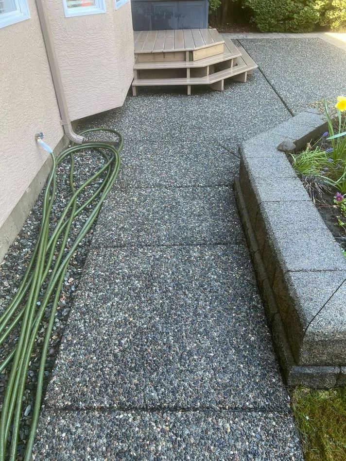 Freshly pressure washed walkway and garden bed